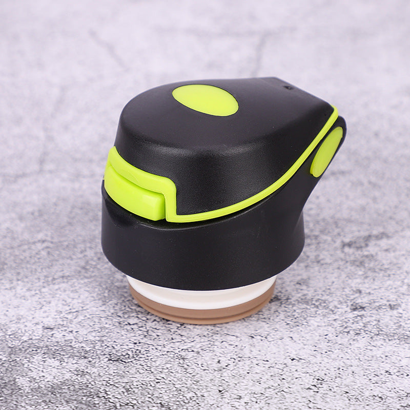 Black and green flip-top lid for a stainless steel bike water bottle. Designed for secure sealing and easy one-handed operation during sports activities.