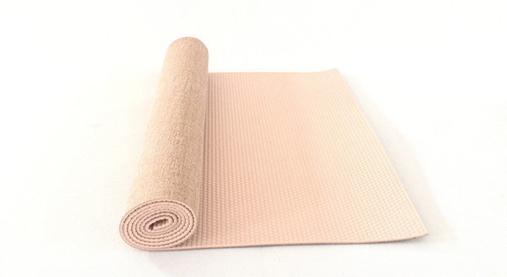 Beige sackcloth yoga mat partially unrolled, showing a textured jute surface and non-slip PVC backing. Ideal for yoga and fitness routines.