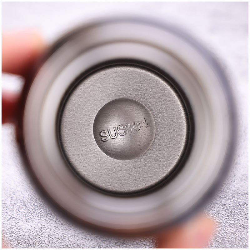 Close-up of the stainless steel interior of a bike water bottle, featuring SUS 304 engraving. Durable and double-walled for heat preservation.