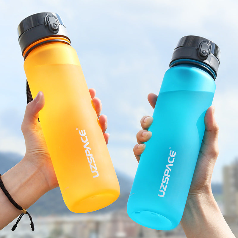 Two colorful sports water bottles in orange and blue, ideal for outdoor travel and fitness. Stylish and durable design with secure flip-top lids.