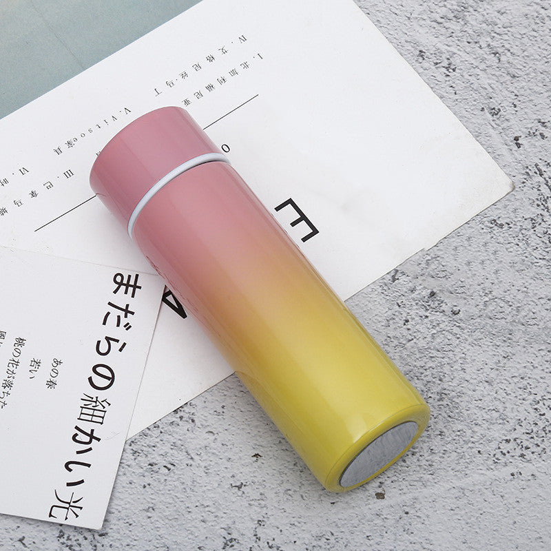 Yellow and pink gradient stainless steel vacuum flask with temperature display, ideal for travel and daily use. Keeps beverages hot or cold for hours.