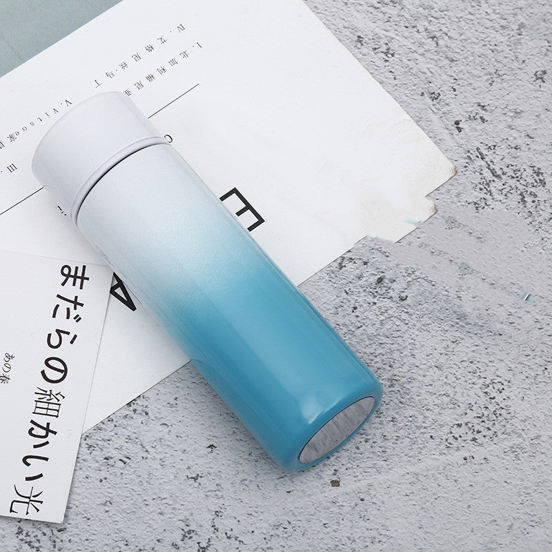 Compact blue and white gradient stainless steel vacuum flask with temperature display, ideal for travel and daily use. Keeps drinks hot or cold for hours.