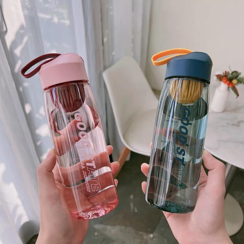 Two portable plastic sports water bottles in pink and blue colors with fall protection straps and scale markings.