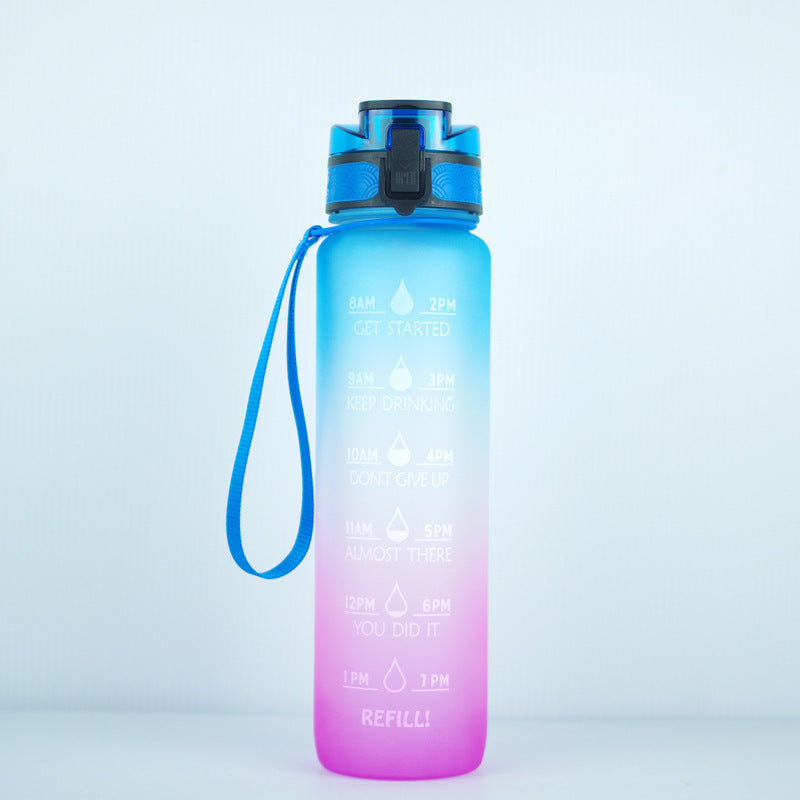 Blue and pink gradient 1000ml water bottle with motivational time markers, leakproof lid, and wrist strap.